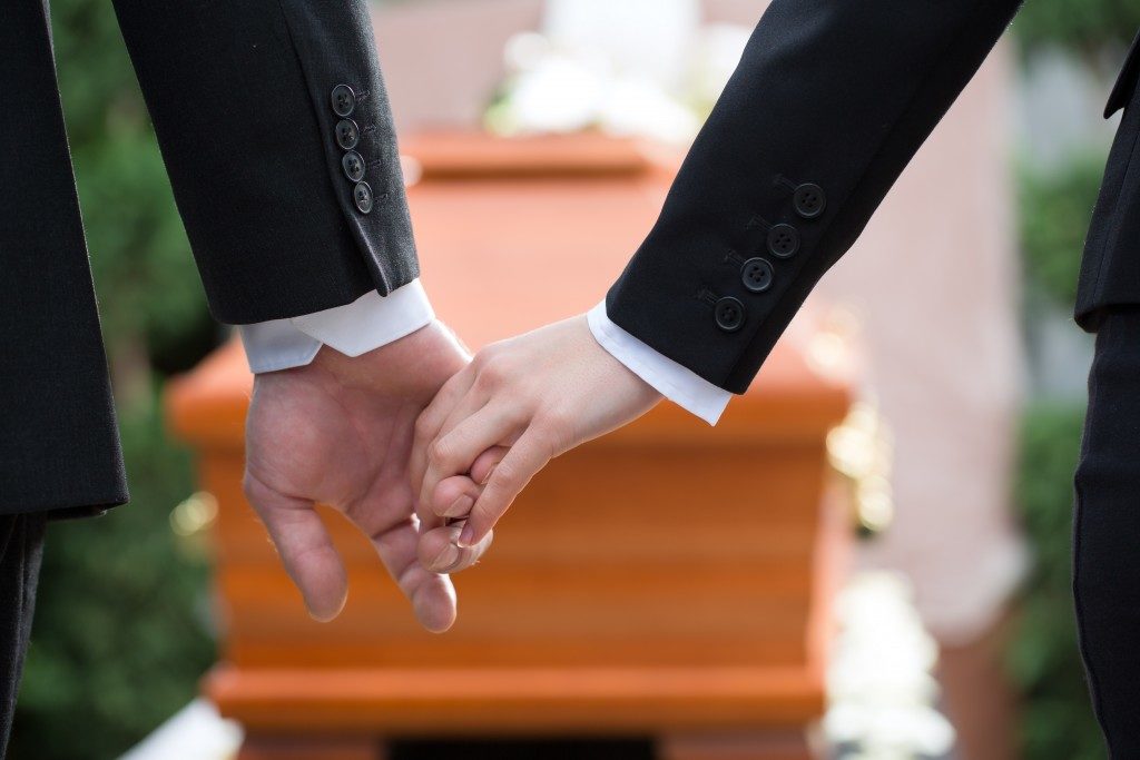 People holding hands because of death of loved one
