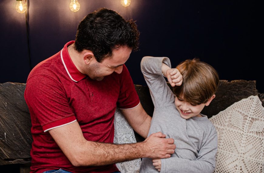 A Man Tickling His Son