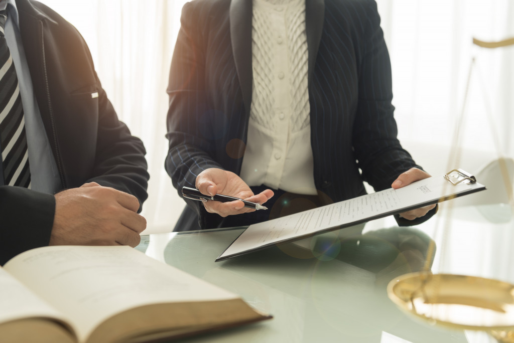 A business professional consulting a lawyer in an office