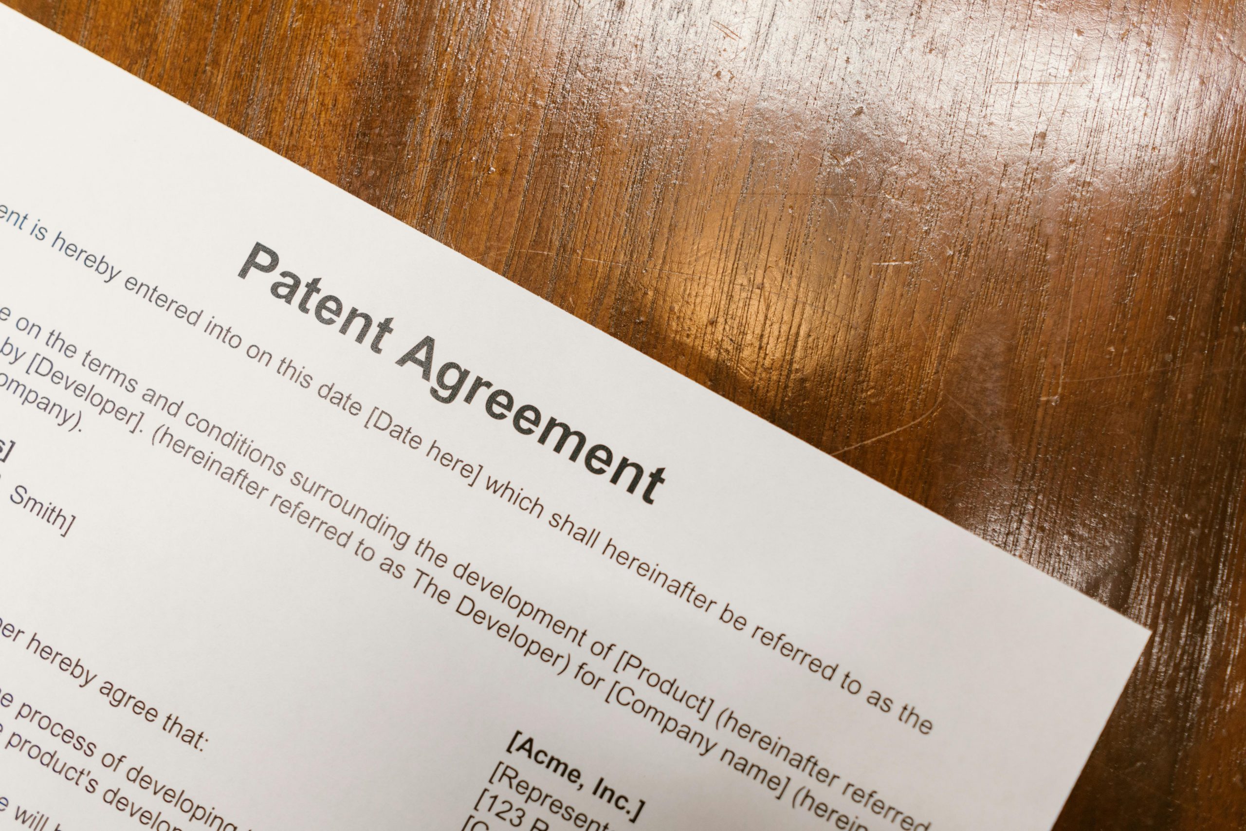 patent agreement document on a wooden table
