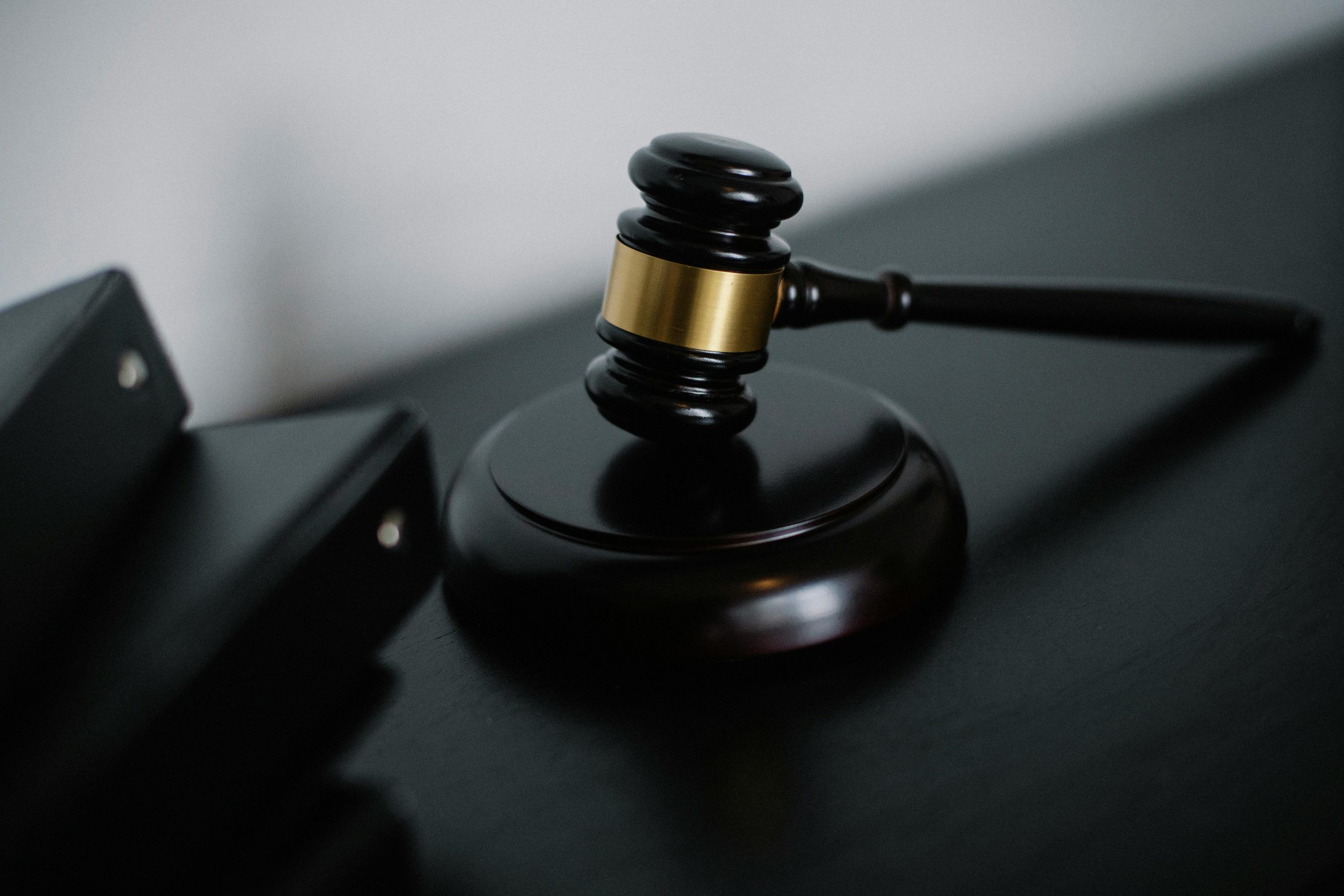 black gavel and striking block on a black surface